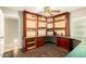 Home office featuring built-in shelves and desk space, with wood floors and lots of natural light at 3554 W Aire Libre Ave, Phoenix, AZ 85053