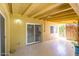 Covered patio with sliding doors, tile flooring, and ample shade at 3554 W Aire Libre Ave, Phoenix, AZ 85053