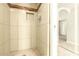 Updated shower with decorative tile accents and tiled shower floor at 3554 W Aire Libre Ave, Phoenix, AZ 85053