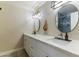 Bathroom features double sink vanity, round mirrors and modern lighting fixtures at 3824 W Carol Ave, Phoenix, AZ 85051