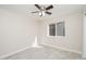 Bright bedroom featuring a ceiling fan, window, neutral walls and light-colored tiled floor at 3824 W Carol Ave, Phoenix, AZ 85051