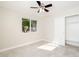 Bedroom featuring a sliding door closet, window, neutral walls and light tiled flooring at 3824 W Carol Ave, Phoenix, AZ 85051