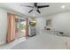 Bright bedroom featuring a ceiling fan, sliding glass doors to the backyard, and neutral decor at 3824 W Carol Ave, Phoenix, AZ 85051