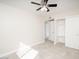 Bedroom displaying a ceiling fan, tiled floor, neutral walls, and closet with sliding doors at 3824 W Carol Ave, Phoenix, AZ 85051