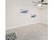 A bright bedroom with tile floors, neutral paint, and artwork, creating a serene atmosphere at 3824 W Carol Ave, Phoenix, AZ 85051