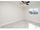 Bedroom features a ceiling fan, window, neutral walls and light-colored tiled flooring at 3824 W Carol Ave, Phoenix, AZ 85051