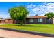 Charming single-story home featuring a well-manicured lawn and mature shade tree at 3824 W Carol Ave, Phoenix, AZ 85051