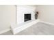 Close-up of a white-painted brick fireplace with decorative accents and tiled flooring at 3824 W Carol Ave, Phoenix, AZ 85051