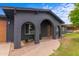 Covered front entrance with brick archways, a charming door, and desert landscaping at 3824 W Carol Ave, Phoenix, AZ 85051