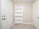 Bright hallway featuring built-in shelving between doorways, offering storage solutions at 3824 W Carol Ave, Phoenix, AZ 85051