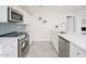 Stylish, updated kitchen with stainless steel appliances, sleek countertops, and a modern backsplash at 3824 W Carol Ave, Phoenix, AZ 85051