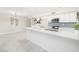 Open-concept kitchen with a large island, tile floors, and stylish lighting, perfect for entertaining at 3824 W Carol Ave, Phoenix, AZ 85051