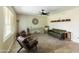 Well-lit living room showcasing tile floors, leather seating, a ceiling fan, and stylish decor at 3824 W Carol Ave, Phoenix, AZ 85051