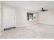 Bright, spacious living room boasts neutral walls, tiled floors, a ceiling fan, and an arched window at 3824 W Carol Ave, Phoenix, AZ 85051