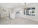 Open concept living area with tile floors seamlessly flowing into the kitchen and dining space at 3824 W Carol Ave, Phoenix, AZ 85051