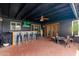 Covered outdoor patio with bar area, ceiling fan, and a TV for entertaining at 3824 W Carol Ave, Phoenix, AZ 85051