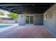 Outdoor brick patio with modern accents, adjacent to the swimming pool at 3824 W Carol Ave, Phoenix, AZ 85051
