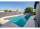 Tranquil backyard featuring a sparkling swimming pool surrounded by desert landscaping at 3824 W Carol Ave, Phoenix, AZ 85051
