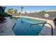 Refreshing swimming pool with sleek design and meticulously landscaped surroundings at 3824 W Carol Ave, Phoenix, AZ 85051