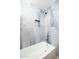 Bathtub with tiled shower featuring blue accent tiles and a convenient built-in niche at 3824 W Carol Ave, Phoenix, AZ 85051