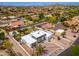 An aerial perspective of the home, showcasing its private pool in a desert landscape at 3951 E Sequoia Trl, Phoenix, AZ 85044