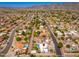 Wide aerial shot of a house, highlighting the pool and surrounding community in a mountain view at 3951 E Sequoia Trl, Phoenix, AZ 85044