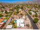 Aerial view of a home and its community, complete with a pool and mountain views at 3951 E Sequoia Trl, Phoenix, AZ 85044