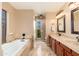 Serene bathroom featuring a soaking tub, double vanity, and elegant tile work at 3951 E Sequoia Trl, Phoenix, AZ 85044