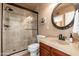 Bathroom showcasing updated fixtures, framed mirror, and a walk-in shower with glass doors at 3951 E Sequoia Trl, Phoenix, AZ 85044