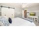 Beautiful bedroom with sliding barn doors, neutral tones, and a ceiling fan at 3951 E Sequoia Trl, Phoenix, AZ 85044