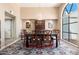 Formal dining room featuring a large window, classic furniture, and a beautiful chandelier at 3951 E Sequoia Trl, Phoenix, AZ 85044