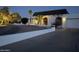 Attractive home exterior with a tile roof, arched windows, and manicured landscaping at twilight at 3951 E Sequoia Trl, Phoenix, AZ 85044