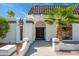 Inviting entrance with desert landscaping and a stylish, arched doorway leading to custom metal doors at 3951 E Sequoia Trl, Phoenix, AZ 85044