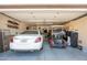 Spacious garage featuring a car, golf cart, and ample storage space at 3951 E Sequoia Trl, Phoenix, AZ 85044