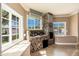 Cozy living area featuring stone fireplace, large windows, and tiled floors at 3951 E Sequoia Trl, Phoenix, AZ 85044