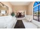 Bright living room featuring large arched windows and view into the formal dining room at 3951 E Sequoia Trl, Phoenix, AZ 85044