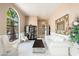 Bright living room featuring an arched window with natural light, and entry to formal dining room at 3951 E Sequoia Trl, Phoenix, AZ 85044