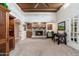 Cozy living room with stone fireplace, beamed ceiling, and a conveniently located wet bar at 3951 E Sequoia Trl, Phoenix, AZ 85044
