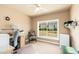 Bright home office space with ample natural light, desk area, and shelving for organized workspace at 3951 E Sequoia Trl, Phoenix, AZ 85044