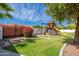Backyard with a wooden swing set, providing a fun play area with plenty of room at 3951 E Sequoia Trl, Phoenix, AZ 85044