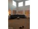 Bright living room featuring high ceilings and large windows at 40724 W Novak Ln, Maricopa, AZ 85138