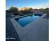 Inviting backyard pool and spa featuring stone surround and lush landscaping at 40724 W Novak Ln, Maricopa, AZ 85138