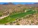 Aerial view of the golf course and homes nestled in a desert landscape at 40853 N 94Th St, Scottsdale, AZ 85262