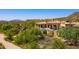 A luxurious home with an outdoor pool, lounge chairs, and beautiful desert landscape at 40853 N 94Th St, Scottsdale, AZ 85262