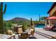 Inviting backyard featuring a pool, a patio, and desert views with a mountain backdrop at 40853 N 94Th St, Scottsdale, AZ 85262