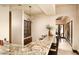 Charming bar area featuring granite countertops, wooden cabinets, and an elegant chandelier for ambient lighting at 40853 N 94Th St, Scottsdale, AZ 85262