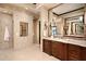Luxurious bathroom showcasing stone tiling, glass shower, and wood cabinets, offering a serene and sophisticated atmosphere at 40853 N 94Th St, Scottsdale, AZ 85262