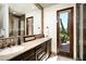 Bathroom with decorative tiling, dual sinks, wood cabinets, and bright, natural light, for a refreshing feel at 40853 N 94Th St, Scottsdale, AZ 85262