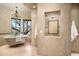 Spa-like bathroom with a freestanding tub, separate shower, and large windows offering stunning views at 40853 N 94Th St, Scottsdale, AZ 85262