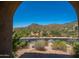 Framed view of desert landscape with diverse vegetation through arched opening at 40853 N 94Th St, Scottsdale, AZ 85262